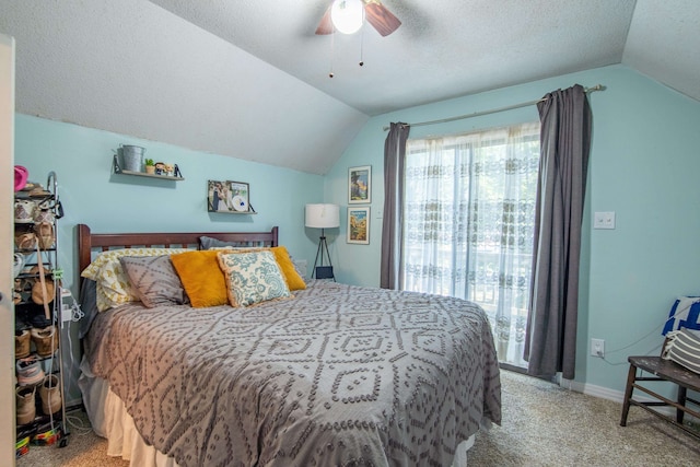 bedroom with ceiling fan, a textured ceiling, vaulted ceiling, and carpet