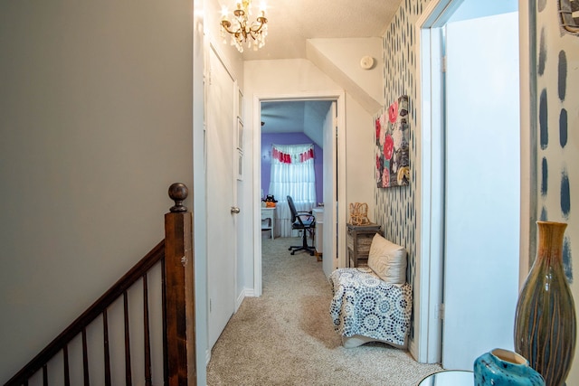 hall featuring a chandelier and carpet