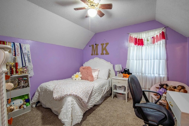 bedroom with vaulted ceiling, ceiling fan, carpet flooring, and a textured ceiling