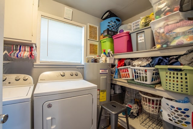 clothes washing area with electric water heater and washing machine and dryer