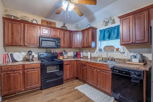 kitchen featuring light wood-type flooring, sink, black appliances, light stone countertops, and ceiling fan