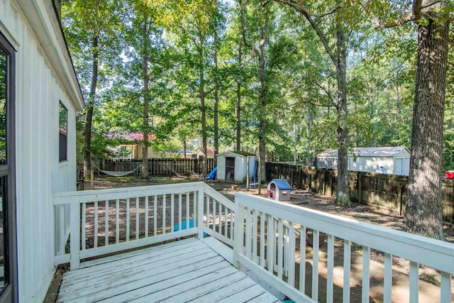 wooden terrace with area for grilling and a storage unit