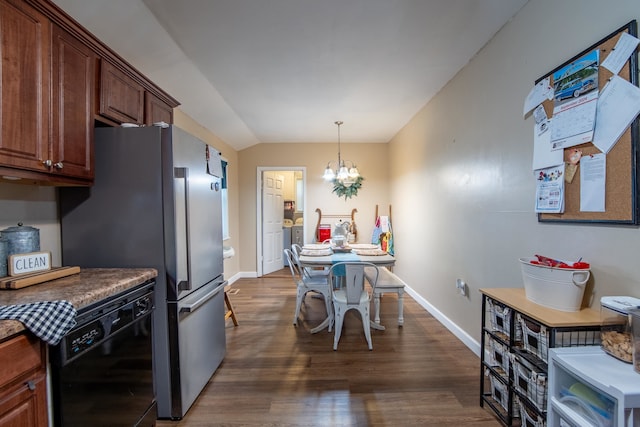 kitchen featuring vaulted ceiling, dark wood-type flooring, dishwasher, decorative light fixtures, and a notable chandelier