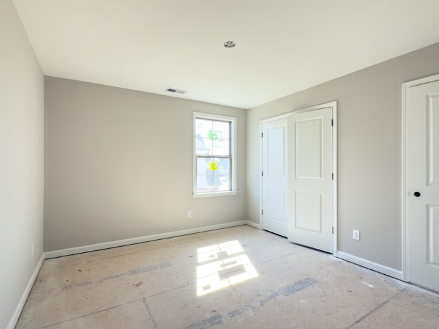 unfurnished bedroom with visible vents and baseboards