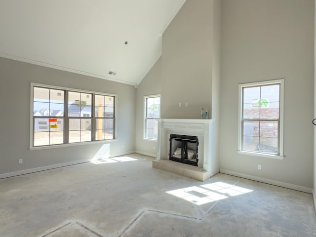 unfurnished living room with high vaulted ceiling, concrete floors, visible vents, baseboards, and a glass covered fireplace