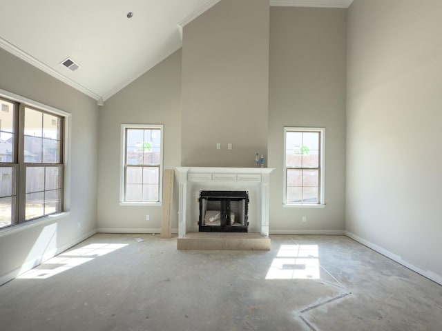 unfurnished living room with high vaulted ceiling, a glass covered fireplace, a healthy amount of sunlight, and visible vents