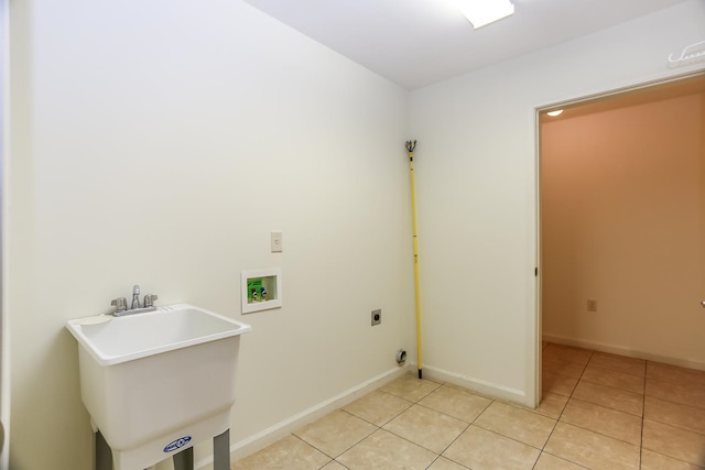 washroom featuring washer hookup, sink, light tile patterned floors, and electric dryer hookup