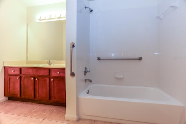 bathroom featuring tiled shower / bath, vanity, and tile patterned flooring