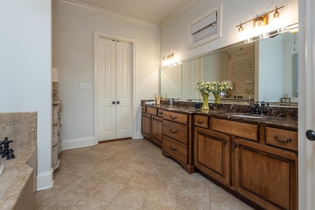 bathroom with ornamental molding, tile patterned flooring, a washtub, and vanity