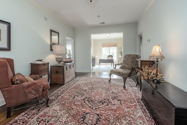 sitting room featuring crown molding and hardwood / wood-style floors