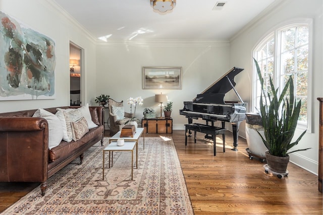 living room featuring wood-type flooring and crown molding