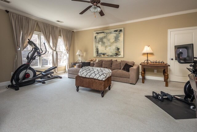 carpeted living room featuring ceiling fan and crown molding