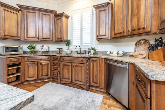 kitchen featuring light stone counters, light hardwood / wood-style floors, sink, ornamental molding, and stainless steel dishwasher