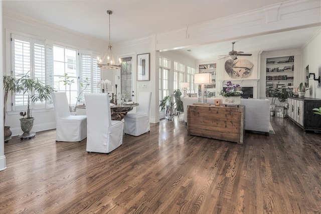 dining space with crown molding, ceiling fan with notable chandelier, and dark hardwood / wood-style floors