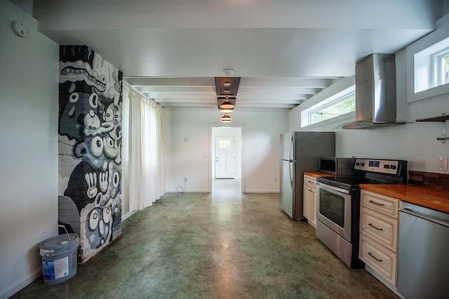 kitchen featuring decorative light fixtures, island exhaust hood, butcher block countertops, concrete floors, and appliances with stainless steel finishes