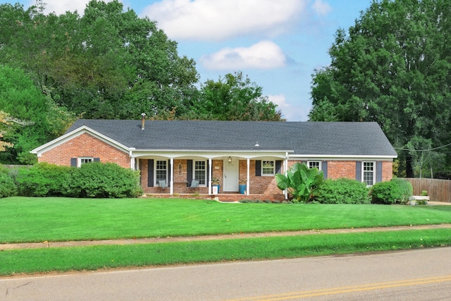 ranch-style home with a porch and a front lawn