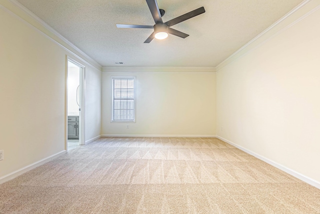 carpeted empty room featuring a textured ceiling, crown molding, and ceiling fan