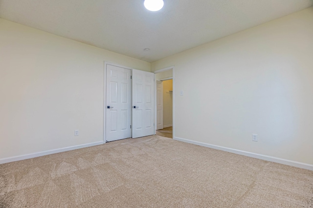 unfurnished bedroom with light carpet