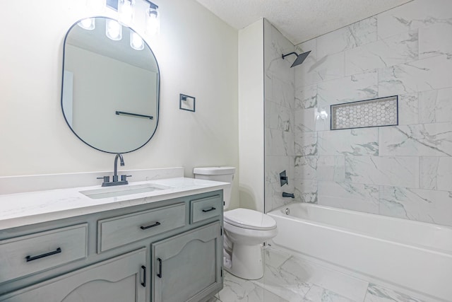 full bathroom featuring tiled shower / bath, vanity, toilet, and a textured ceiling