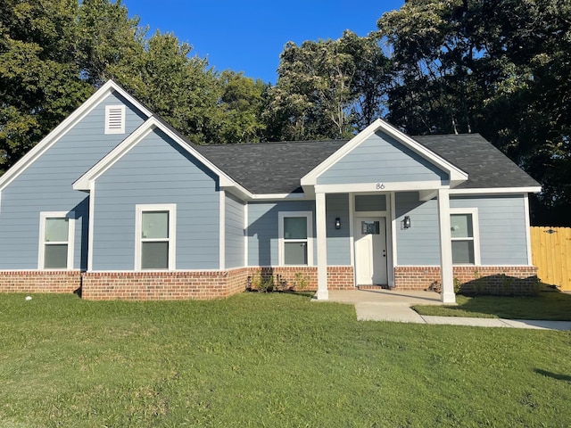 view of front of property featuring covered porch and a front yard