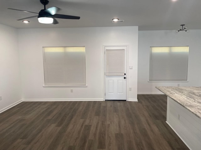 spare room featuring ceiling fan and dark wood-type flooring