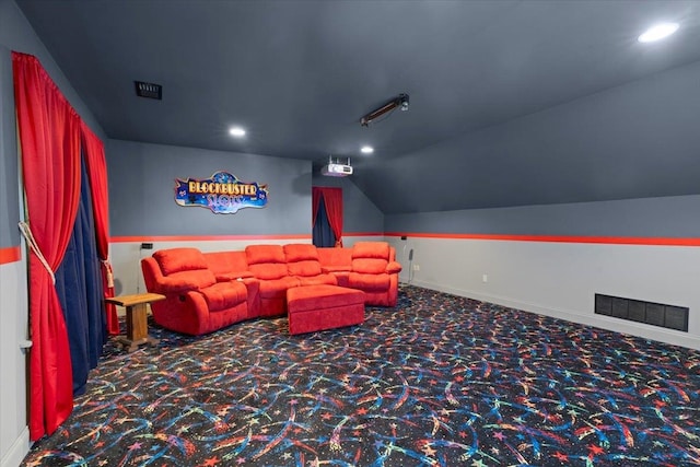 carpeted home theater room with lofted ceiling