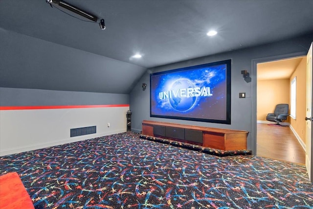 home theater with lofted ceiling and carpet