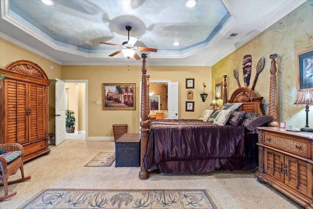 carpeted bedroom featuring a raised ceiling, ornamental molding, and ceiling fan