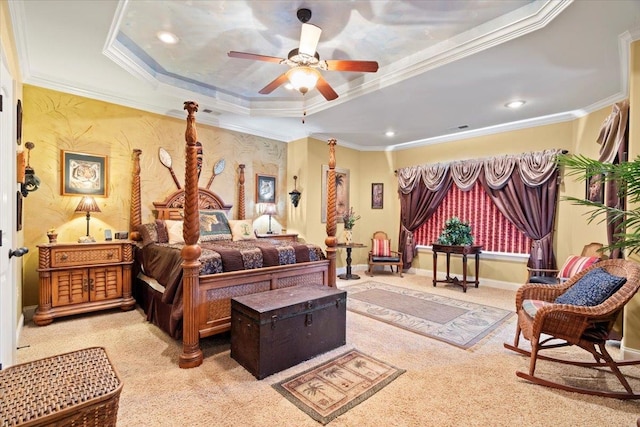 bedroom featuring a tray ceiling, ceiling fan, light colored carpet, and crown molding