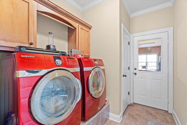 laundry area featuring washing machine and dryer, ornamental molding, and cabinets