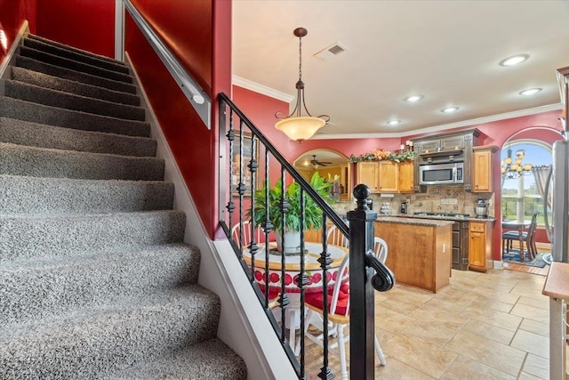 stairway featuring ornamental molding