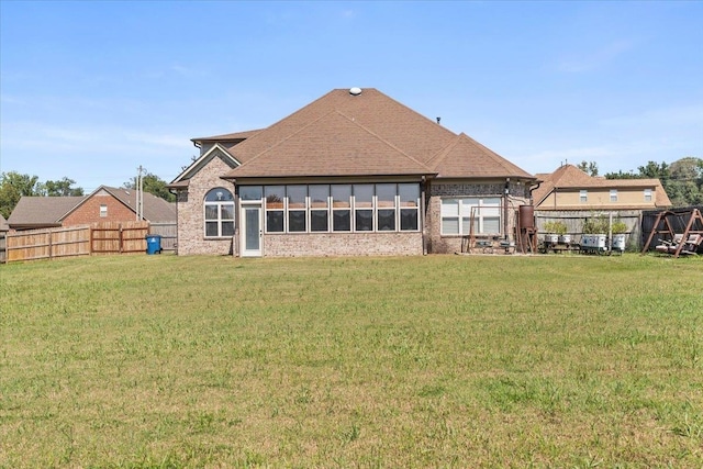 rear view of house with a yard