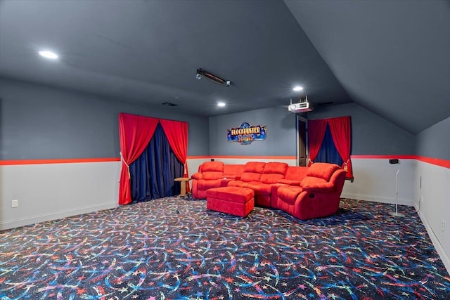 cinema with carpet floors and vaulted ceiling