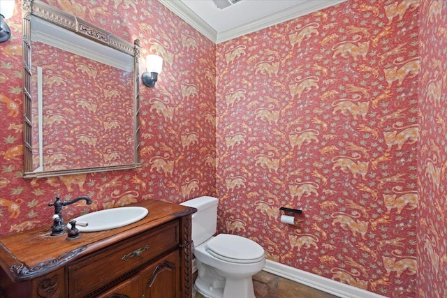 bathroom with vanity, crown molding, and toilet