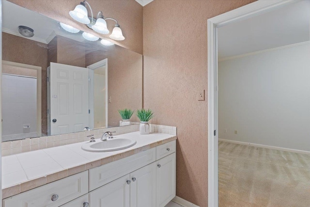 bathroom with crown molding and vanity