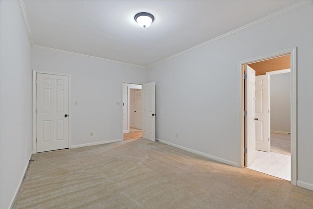 unfurnished room with ornamental molding and light colored carpet