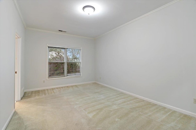 spare room featuring ornamental molding and light colored carpet