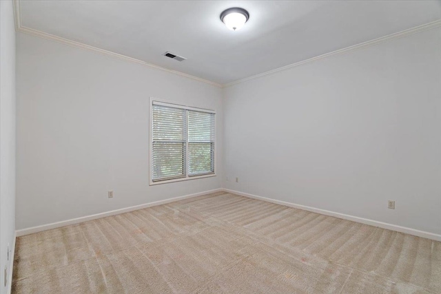 spare room with light colored carpet and ornamental molding