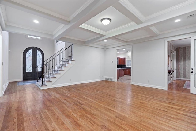 foyer with beamed ceiling, coffered ceiling, light hardwood / wood-style flooring, and french doors