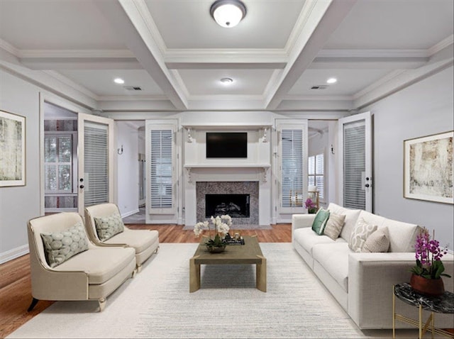 living room featuring a wealth of natural light, a premium fireplace, and hardwood / wood-style flooring