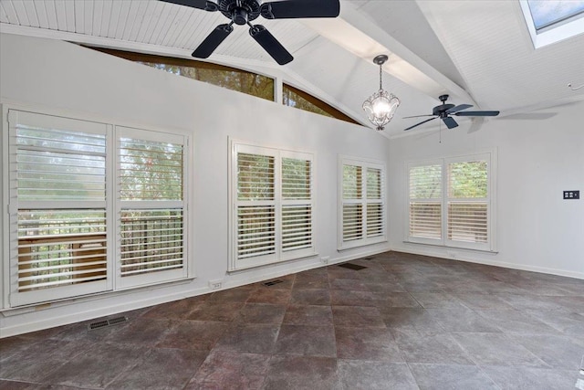 empty room featuring vaulted ceiling with skylight, ceiling fan, and plenty of natural light