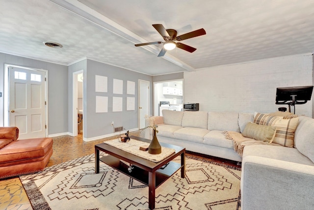 living room with ceiling fan and ornamental molding