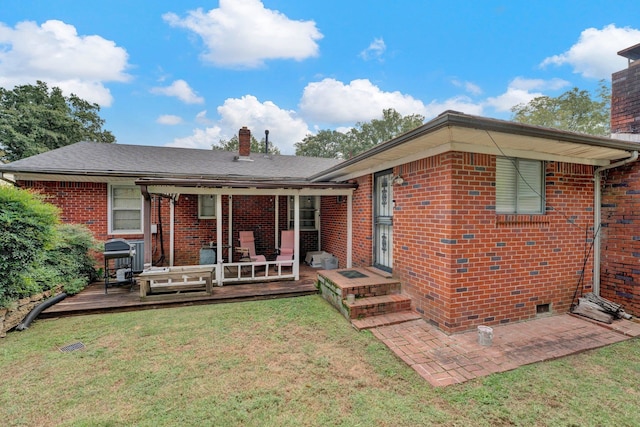 exterior space featuring a deck and a front lawn