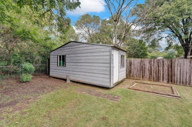 view of outbuilding with a yard