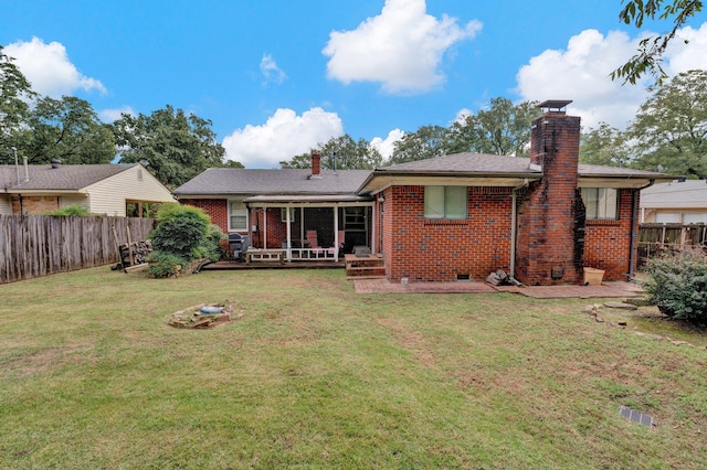 rear view of property featuring a yard