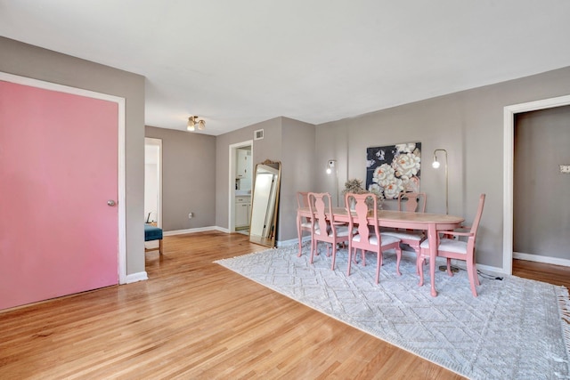 dining space with light hardwood / wood-style floors