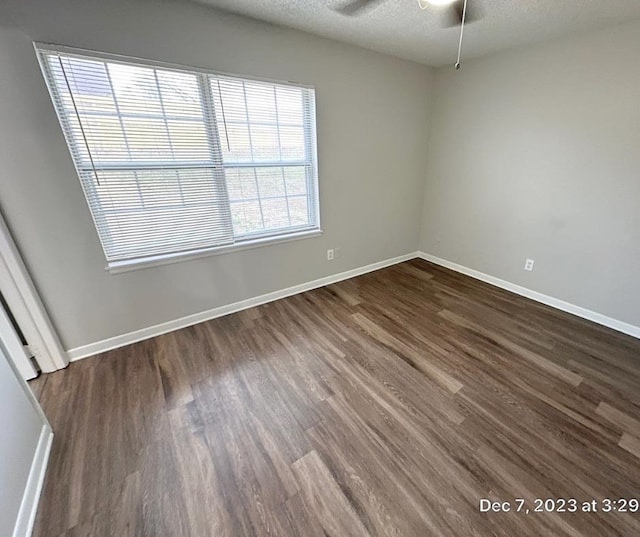 spare room featuring ceiling fan, a textured ceiling, and dark hardwood / wood-style flooring