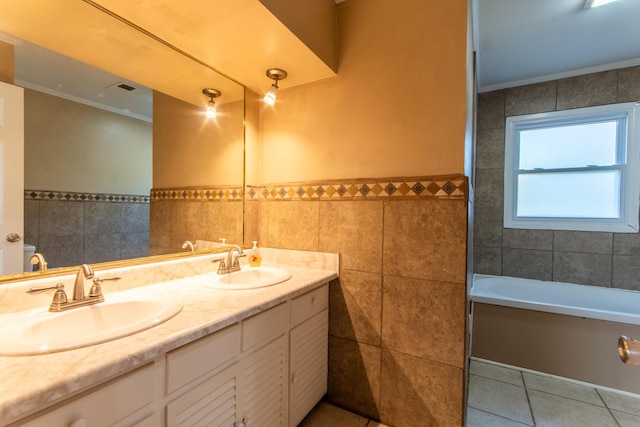 bathroom with vanity, ornamental molding, a bathing tub, tile patterned floors, and tile walls