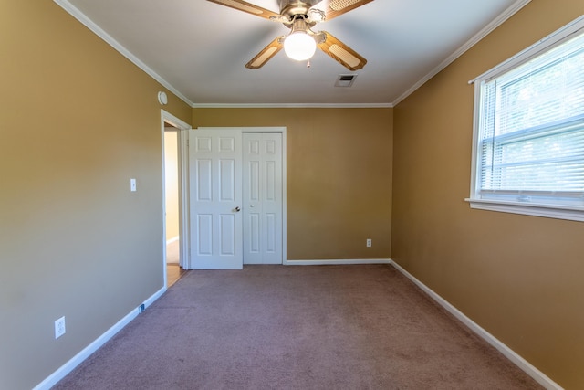 unfurnished bedroom featuring light carpet, a closet, ceiling fan, and ornamental molding