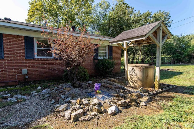 view of property exterior with a lawn and a gazebo